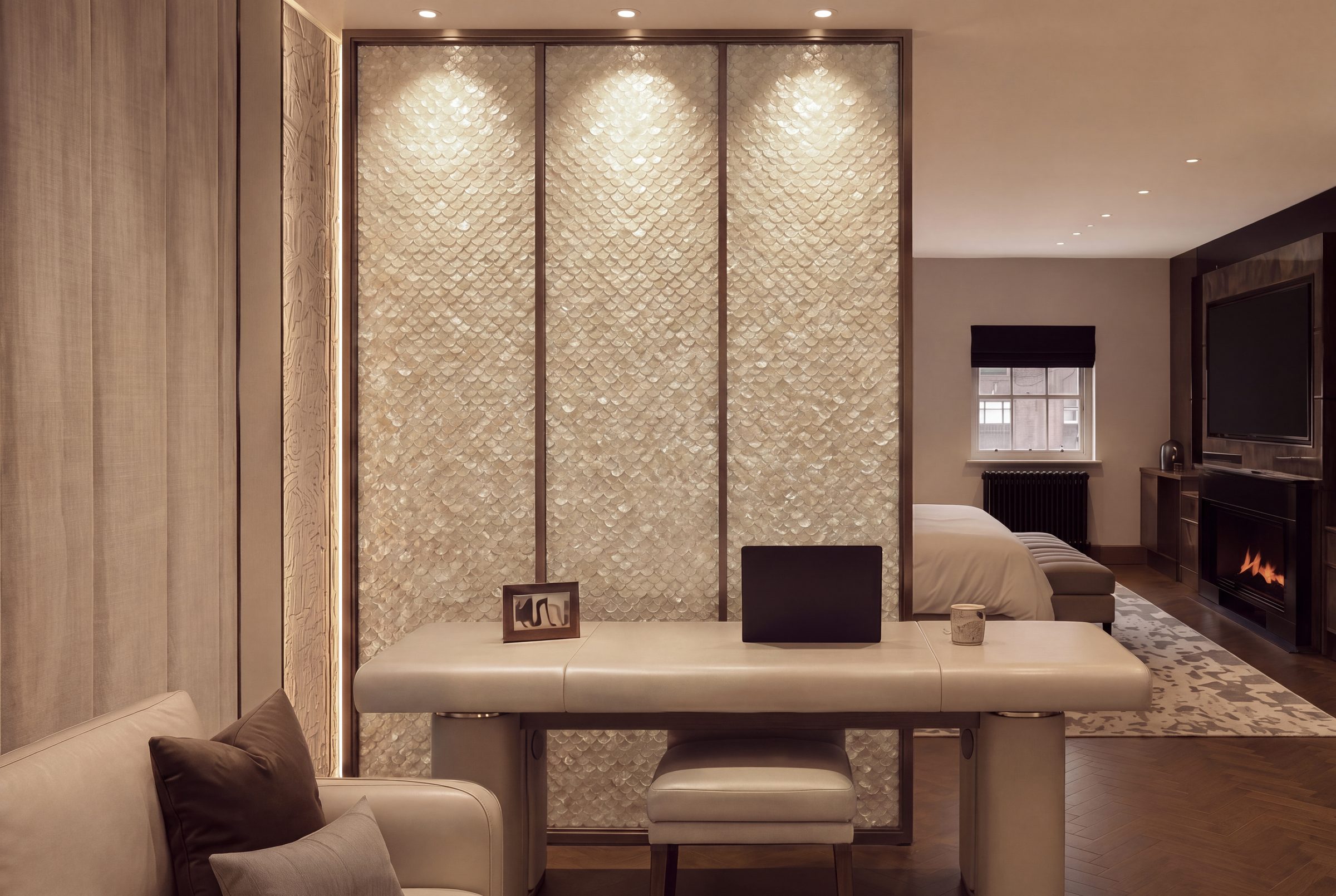 Mother-of-pearl panelled joinery wall in a fitted living space